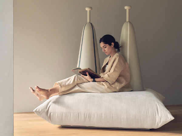 Woman sits on modern furniture piece 